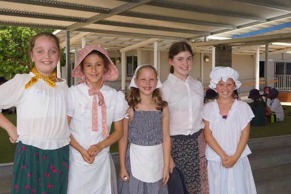 Some girls in clothing to represent the 1800s.