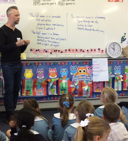 Cam Semmen with some Year 1 students sharing his knowledge of poetry writing.